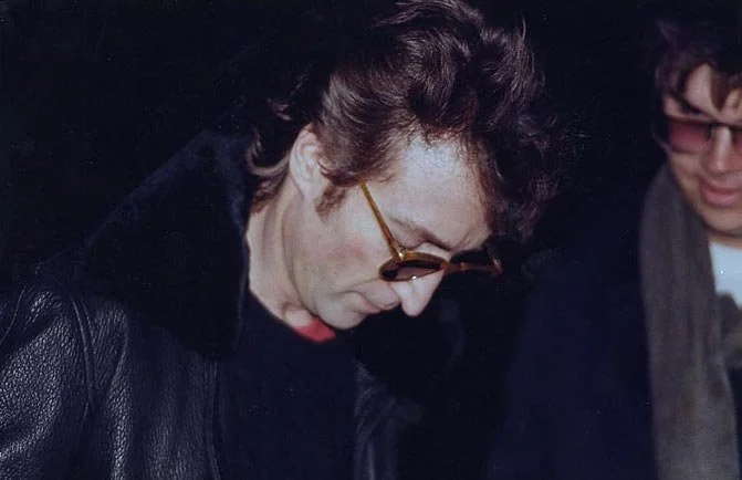 John Lennon signing an autograph for Mark David Chapman, the man that would kill him five hours after this photo was taken.
