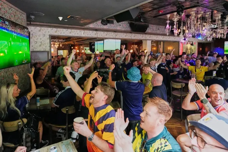 The economic benefits of the World Cup are more pronounced for bars than for hotels. The photo shows fans watching the game inside a bar. (Associated Press)